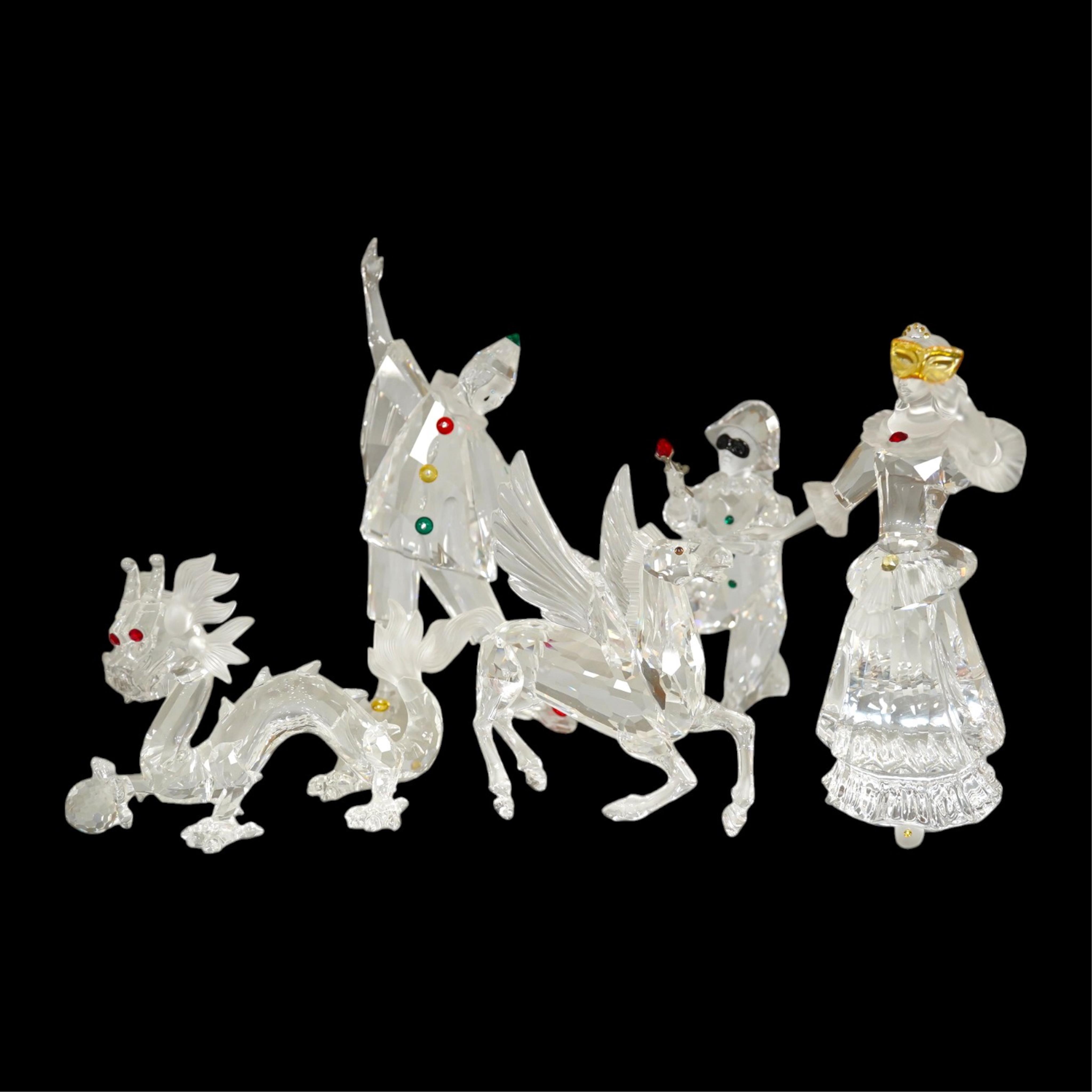 Five Swarovski crystal figures including Masquerade Columbine, Masquerade Harlequin, Masquerade Pierrot, a Chinese Dragon and Pegasus. Condition - good